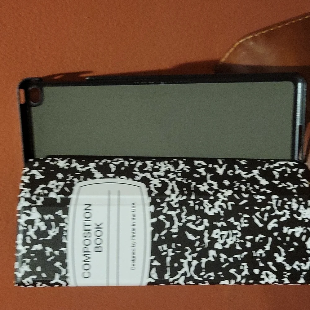 IPad min cover that looks like a school composition book and it black and white